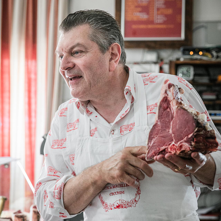 Chef Dario Cecchini holding a steak in his butcher shop