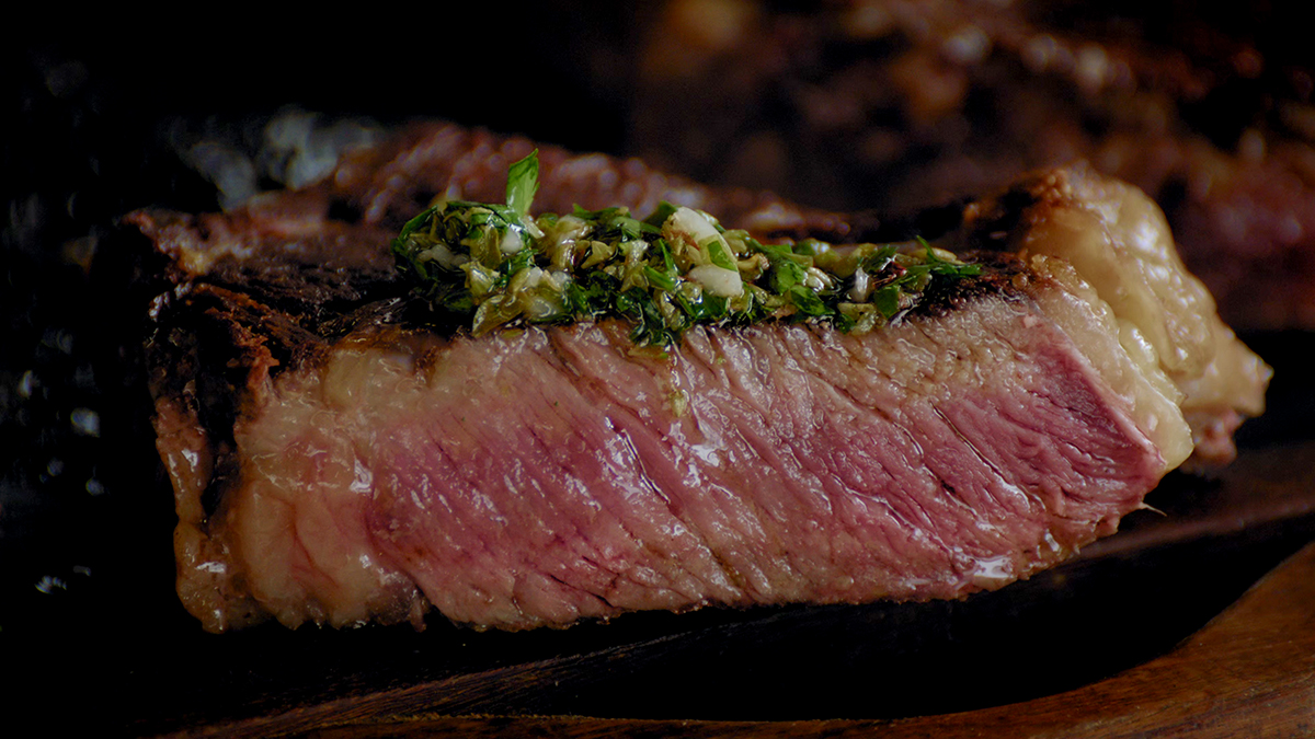 Closeup of Francis Mallmann's perfect steak with chimichurri sauce