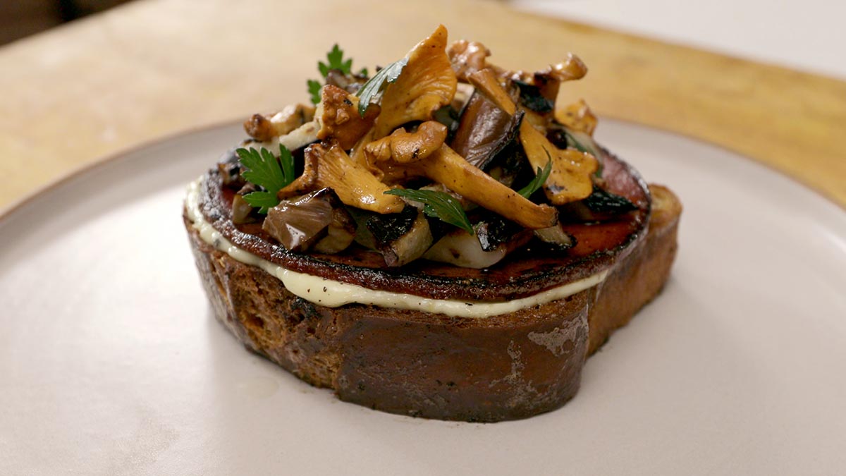 Eggplant, Bologna & Mushroom Burnt Toast. Edward teaches how to utilize one of his signature flavors: Burnt. Discover the gentle balance of burning without charring, as you learn how to master the Maillard reaction and release deliciousness from the simplest ingredients. Recreate Edward’s his favorite childhood sandwich and learn how to sear and caramelize as you elevate the gentle flavors of eggplant, mushroom and bologna, along with roasting garlic to enhance mayonnaise.