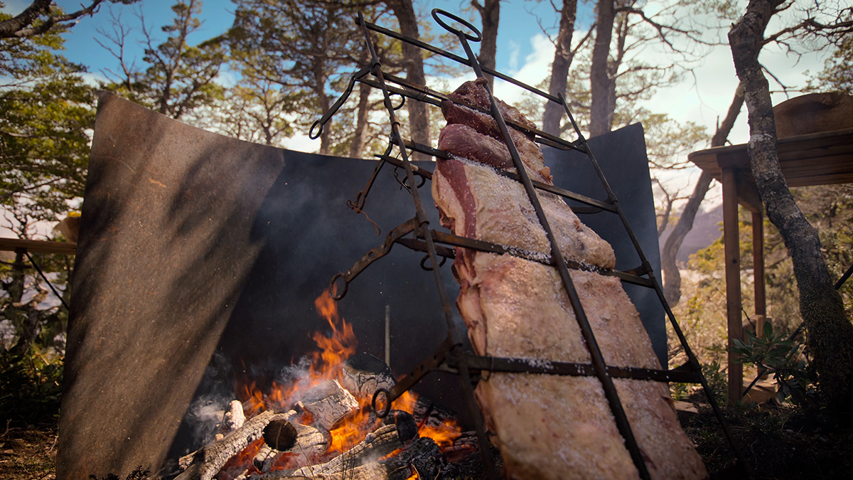 Asador. Francis teaches how to build a makeshift grill and cooks freshwater brook trout fish “a la vara”, crucified asador-style over an open flame.