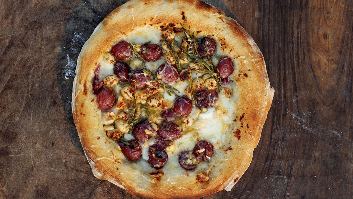 Grape & Hazelnut Pizza. Blow minds with this extraordinary combination of grapes, hazelnuts, rosemary, and Parmesan, loaded on a crispy base.
