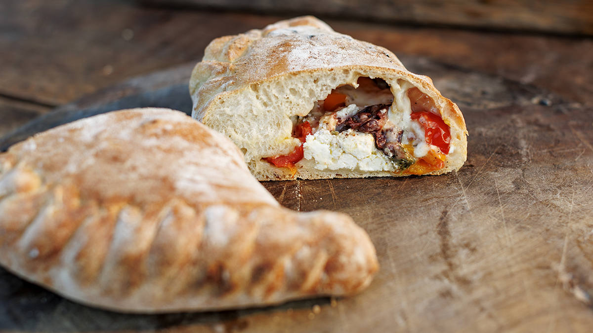Ricotta & Olive Calzone. Transform your dough into a beautiful calzone and stuff it with ricotta cheese, olives, cherry tomatoes, oregano, and Parmesan.